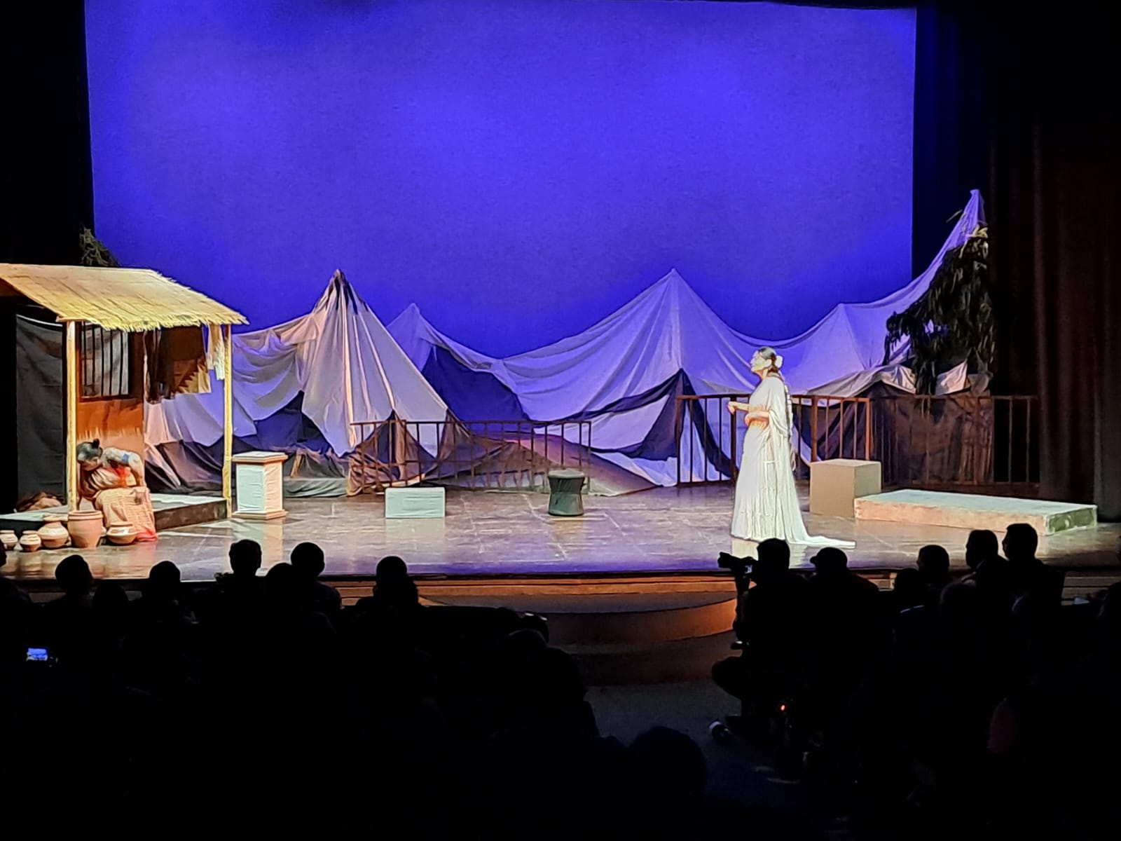 Wide view of a stage set with draped mountain scenery